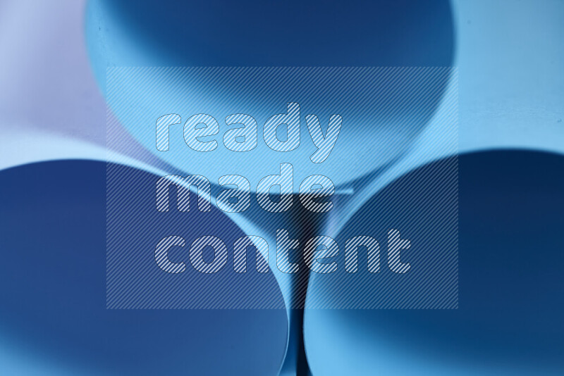 The image shows an abstract paper art with circular shapes in varying shades of blue
