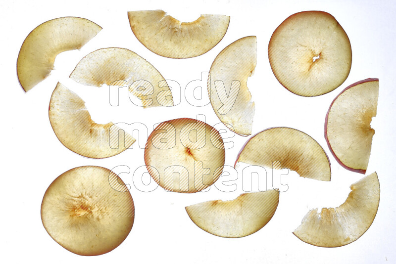 Peach slices on illuminated white background