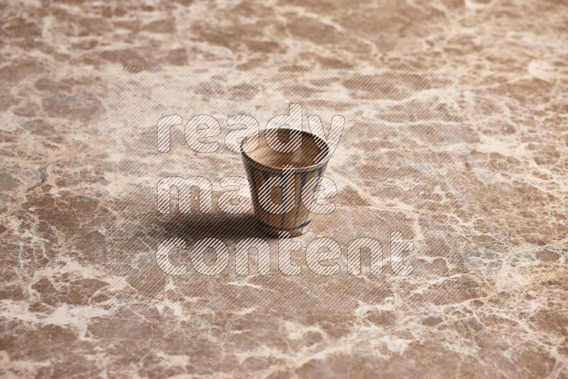 Pottery Cup on Beige Marble Flooring