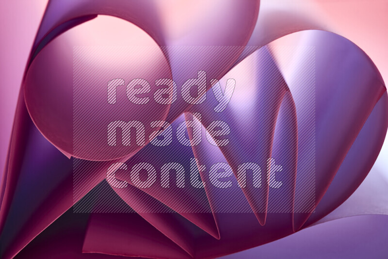 An artistic display of paper folds creating a harmonious blend of geometric shapes, highlighted by soft lighting in purple tones