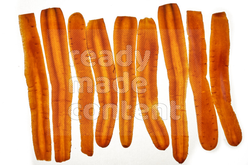 Carrots slices on illuminated white background