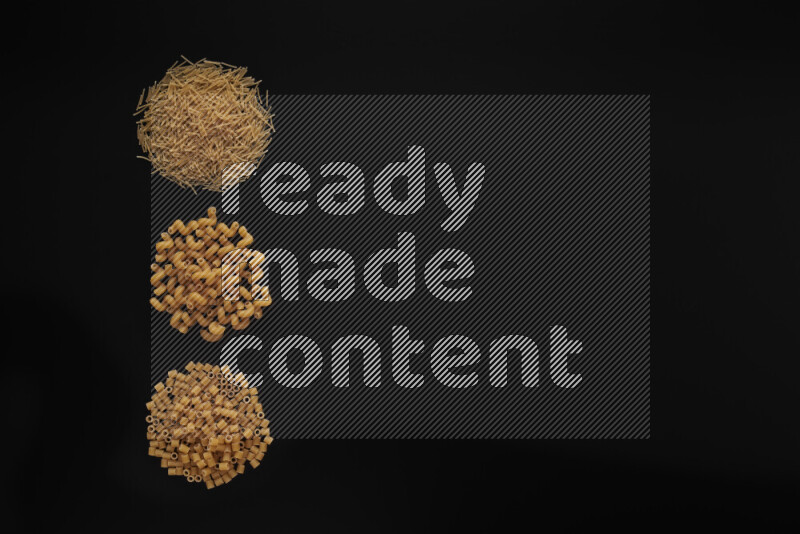 Different pasta types in 3 bunches on black background