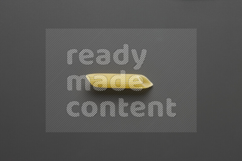 Penne pasta on grey background