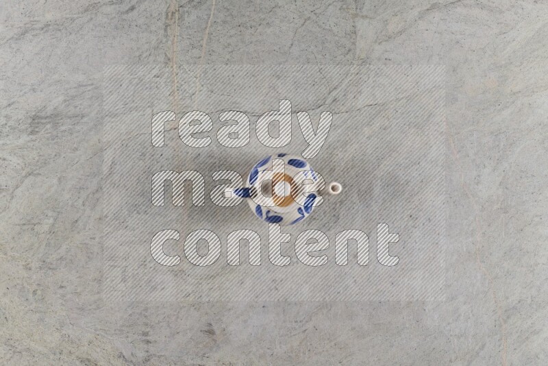 A pottery teapot on grey marble background