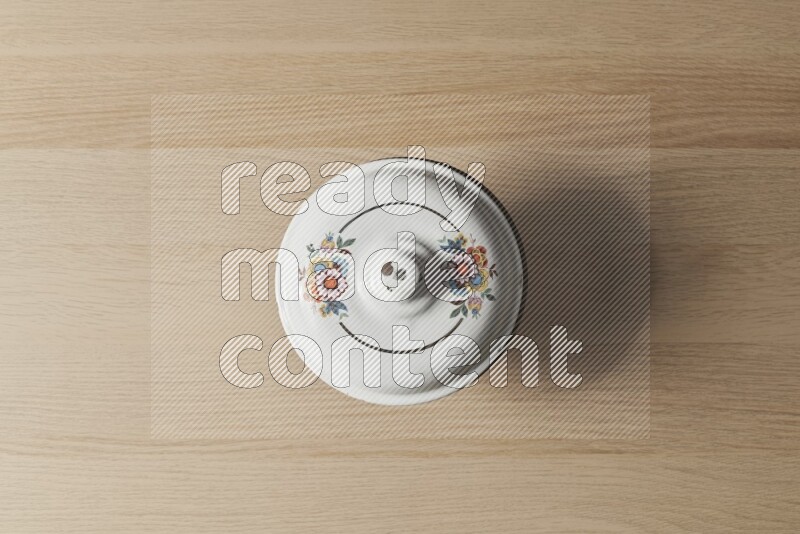 A vintage metal pot on light wooden background