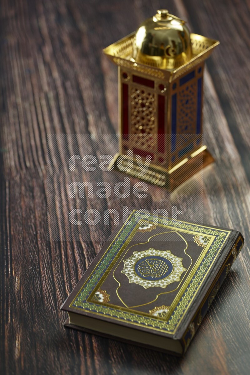 A golden lantern with different drinks, dates, nuts, prayer beads and quran on brown wooden background