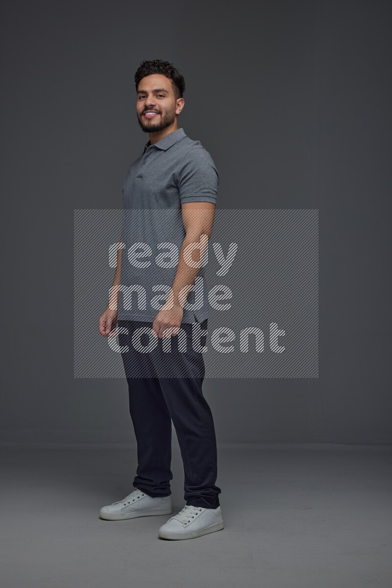 A man wearing casual making multi stand poses  eye level on a gray background