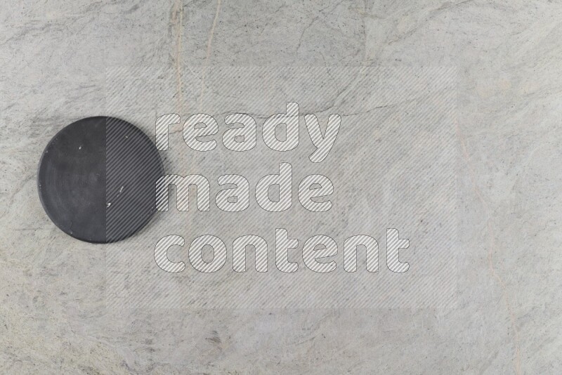 A pottery coaster on grey marble background