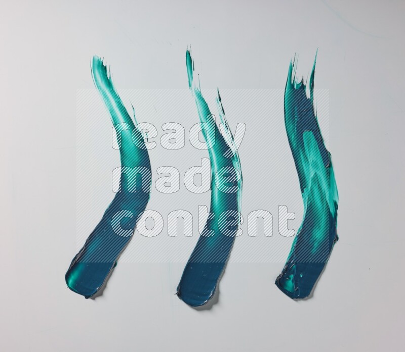 Turquoise painting knife strokes on white background
