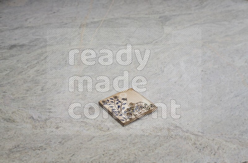 Top view shot of a pottery coaster\ tile on beige marble flooring