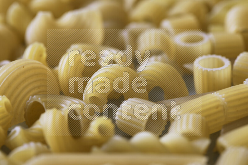 Different pasta types on light blue background