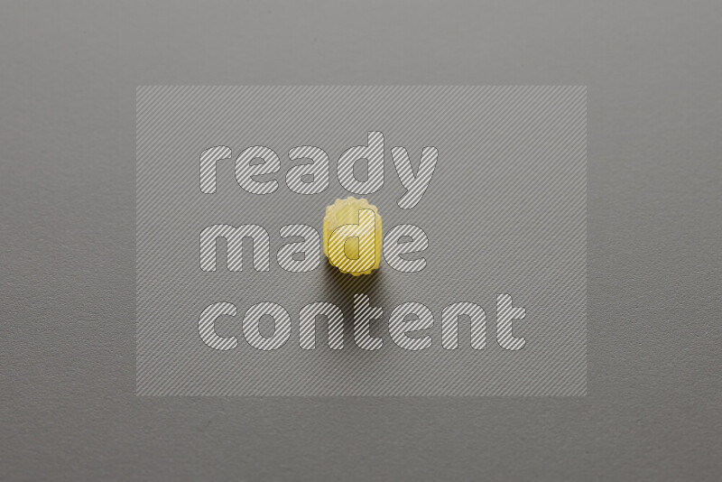 Small rings pasta on grey background