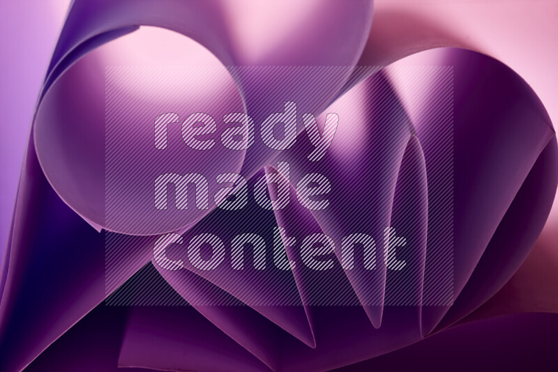 An artistic display of paper folds creating a harmonious blend of geometric shapes, highlighted by soft lighting in purple tones