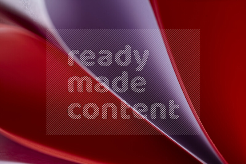 An abstract art showing purple and red paper sheets arranged in an overlapping curves