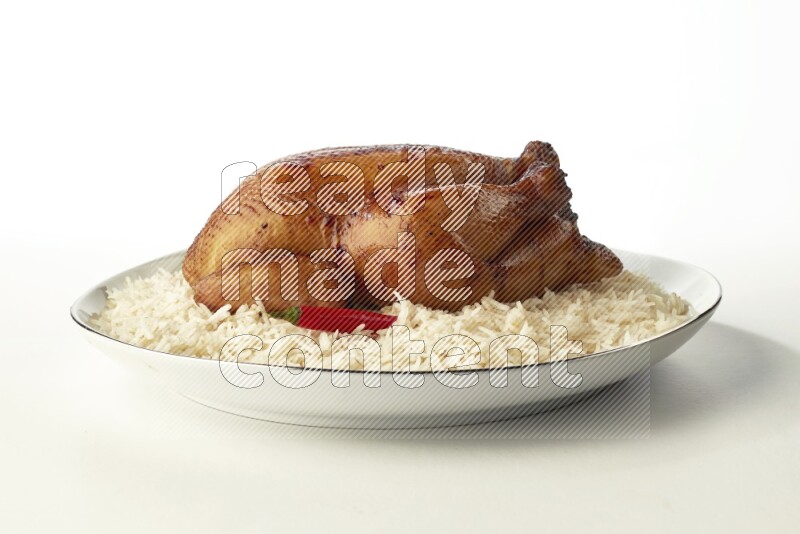 white  basmati Rice with  whole roasted chicken  on a white plate with a silver rim direct  on white background