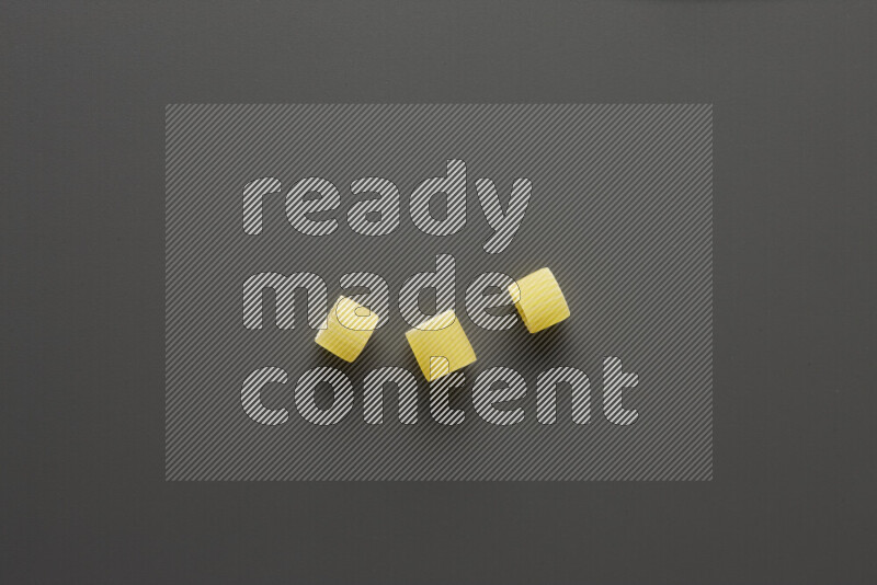 Big rings pasta on grey background