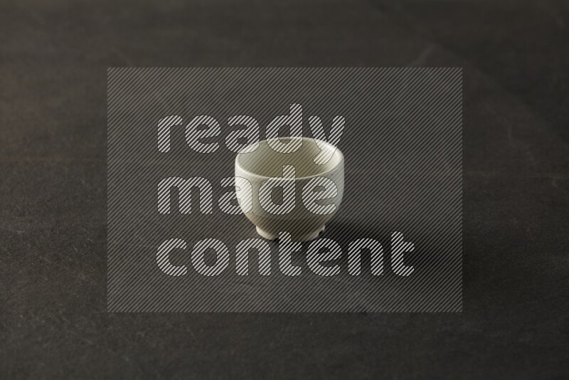 multi color round sauce bowl on grey textured countertop