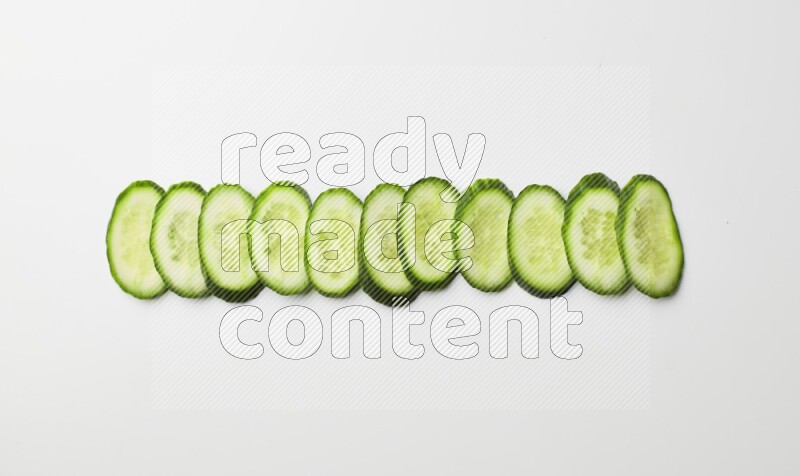 Multiple cucumber slices on white background