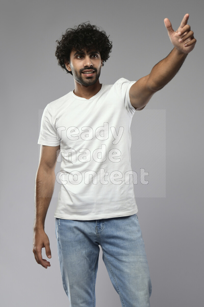 A man wearing casual standing and making a hand gesture on white background