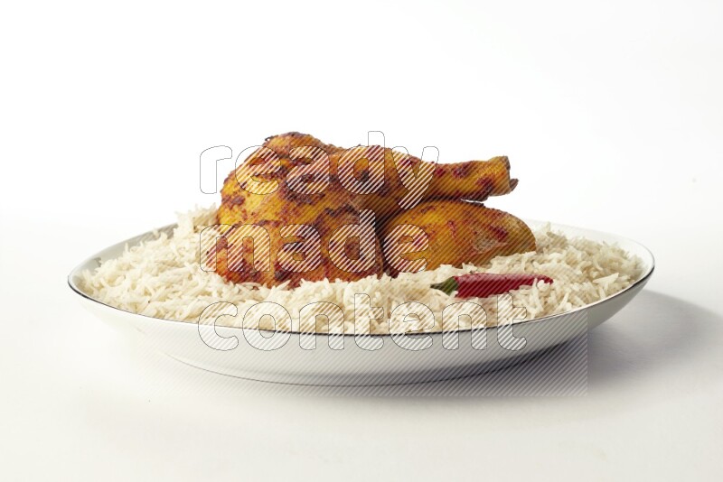 white basmati Rice with kabsa chicken pieces on a white plate with a silver rim direct on white background