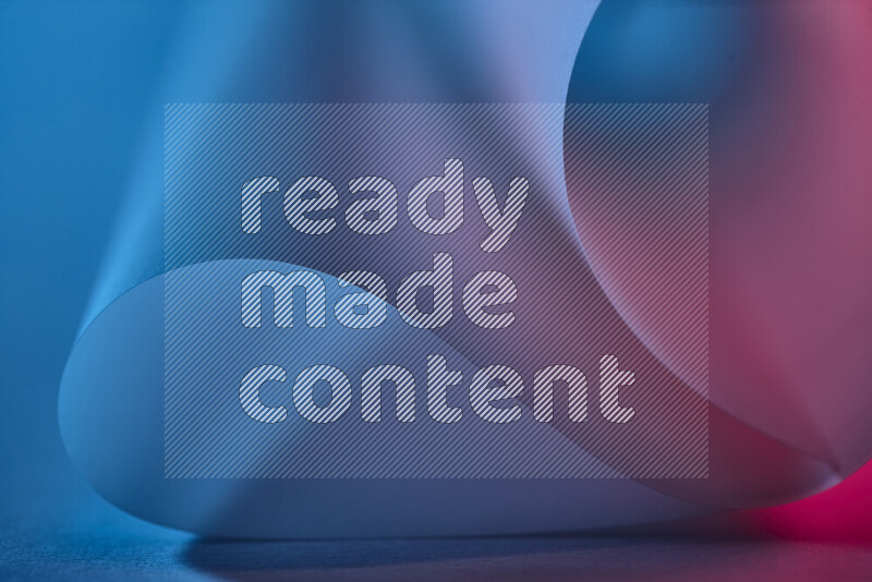 An abstract art piece displaying smooth curves in blue and pink gradients created by colored light