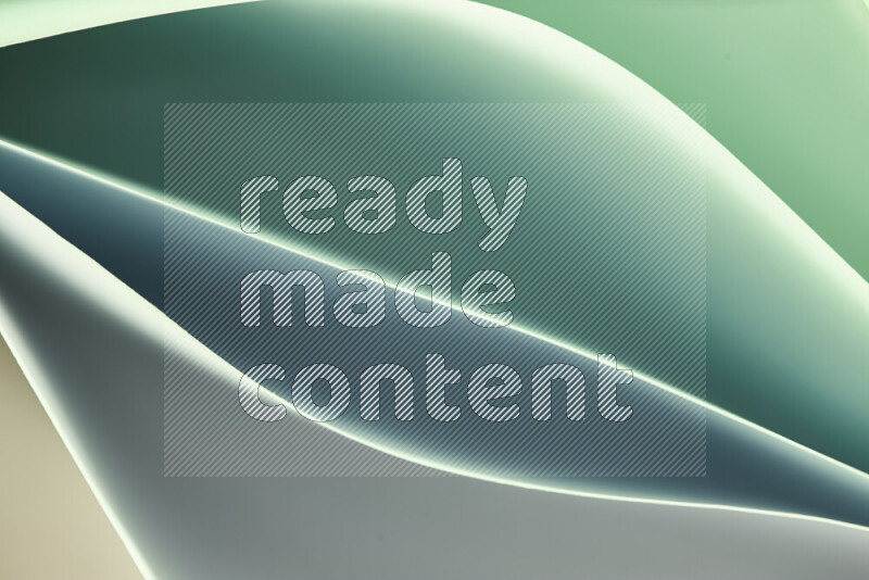 This image showcases an abstract paper art composition with paper curves in green gradients created by colored light