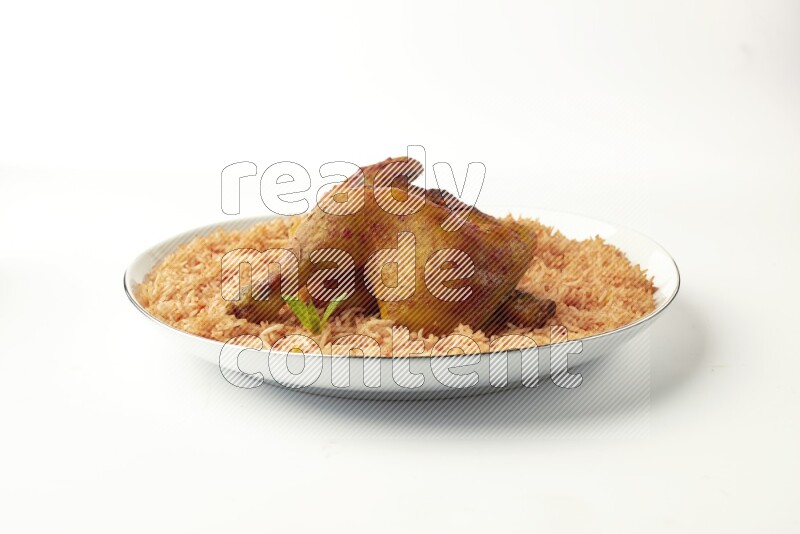 red basmati Rice with  kabsa chicken pieces on a white plate with a silver rim direct  on white background