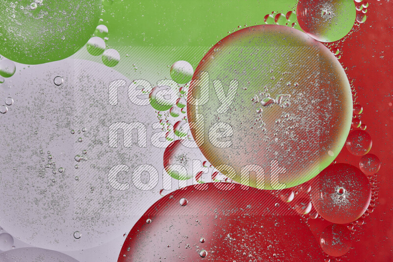 Close-ups of abstract oil bubbles on water surface in shades of red, green and white