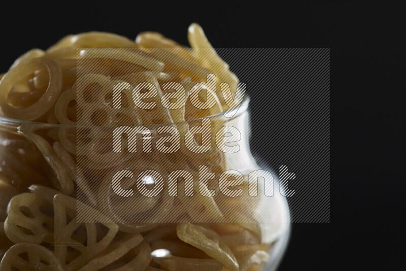 Snacks in a glass jar on black background