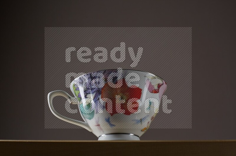 Low angle shot of a decorated cup on grey background