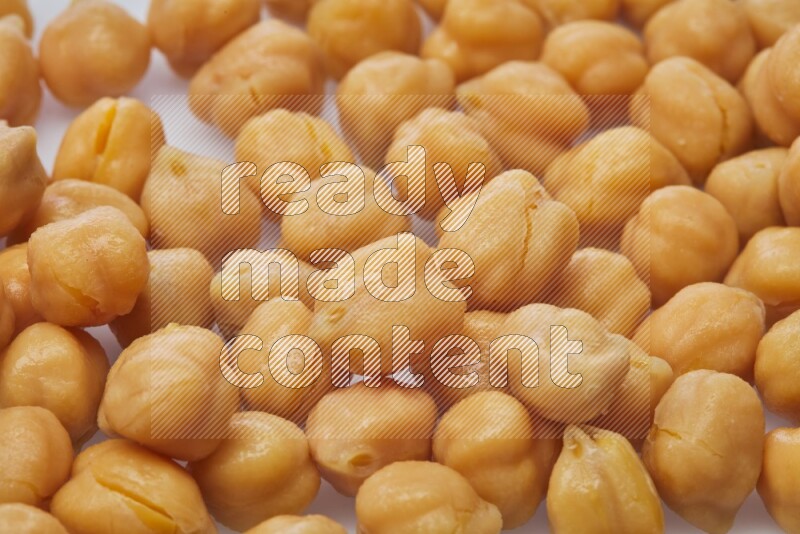 Close up shot of boiled chickpeas on white background