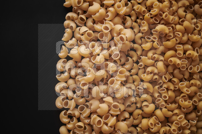Different pasta types on black background