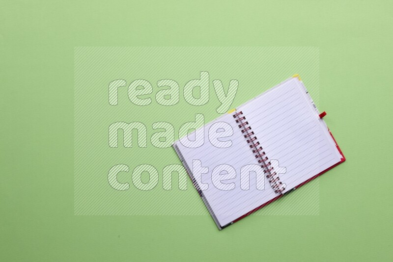 A blank open notebook on green background