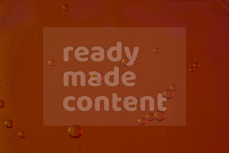 Close-ups of abstract water drops on oil Surface on red background