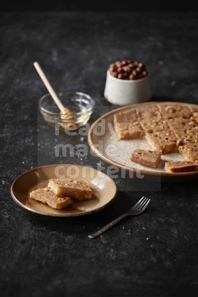 Basbousa with nuts and honey in a dark setup