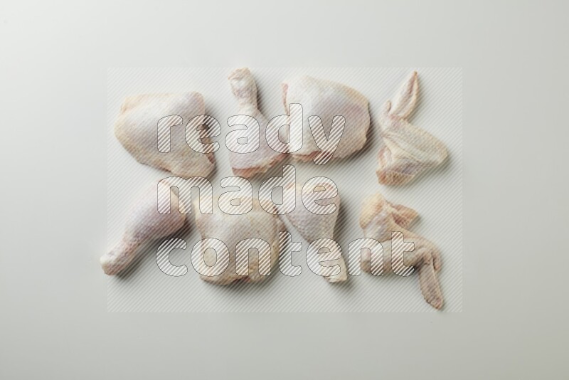 Mixed fresh chicken pieces direct on a white background