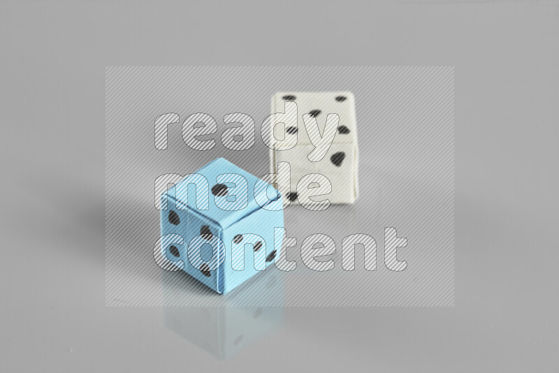 Origami dice on grey background