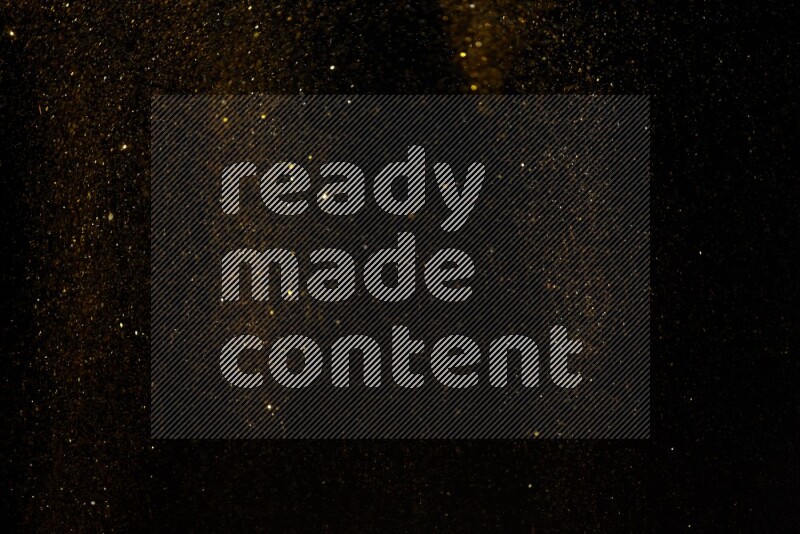 Gold glitter powder isolated on black background