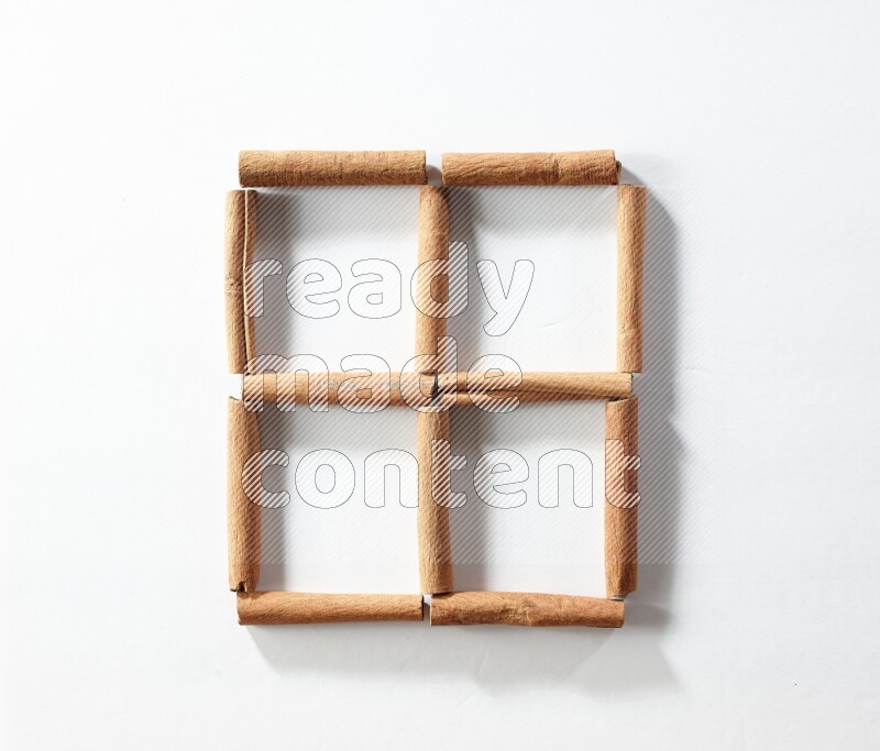 4 empty squares of cinnamon sticks on white flooring