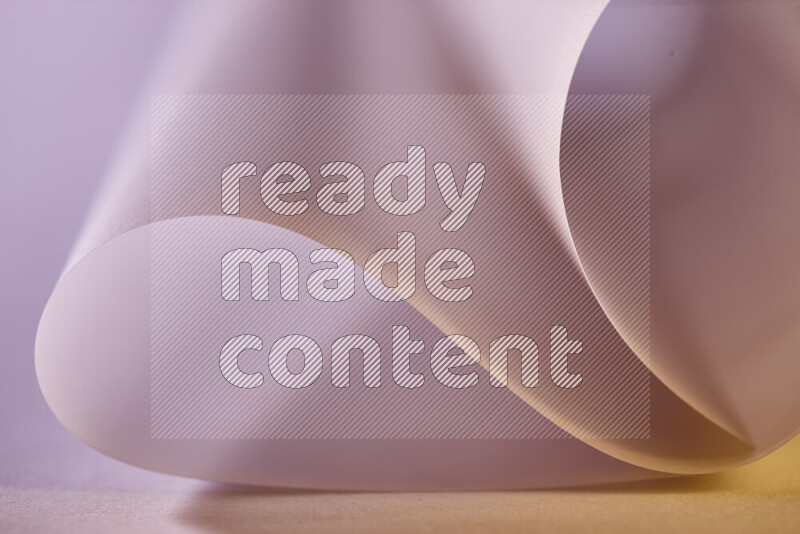 An abstract art piece displaying smooth curves in gold gradients created by colored light