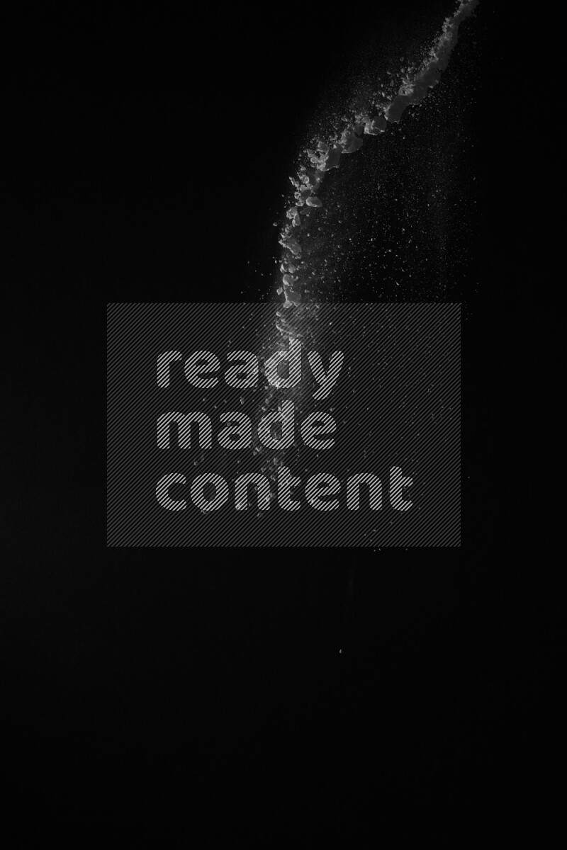 A side view of white powder explosion on black background