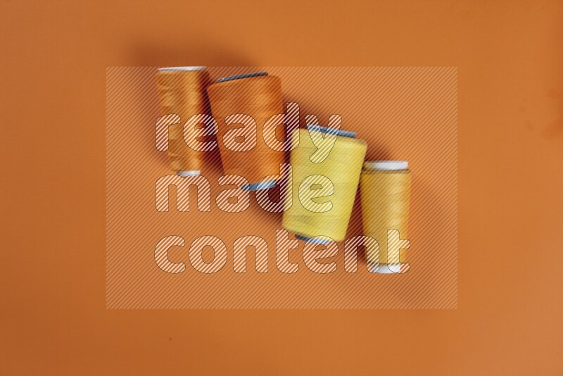 A yellow collection of sewing and tailoring tools arranged on a orange background
