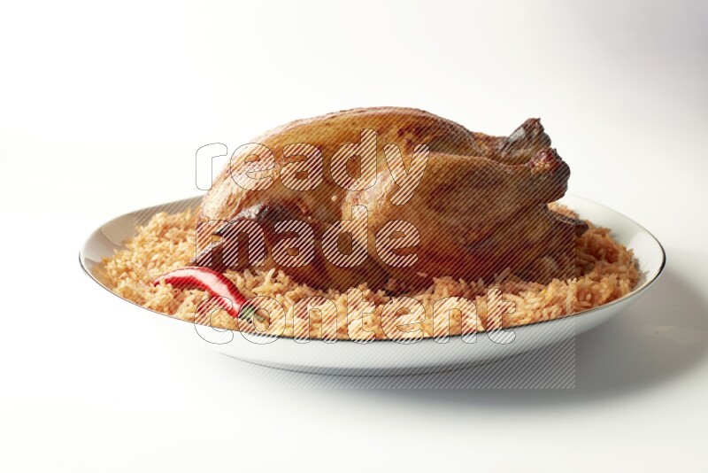 red basmati Rice with whole roasted chicken on a white plate with a silver rim direct on white background