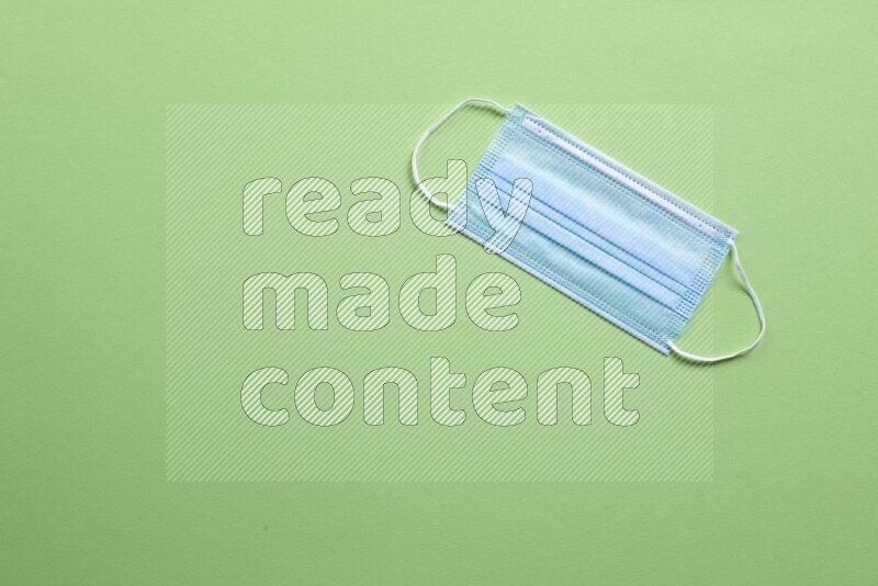 A face mask on green background