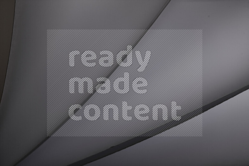 An abstract art showing grey paper sheets arranged in an overlapping curves