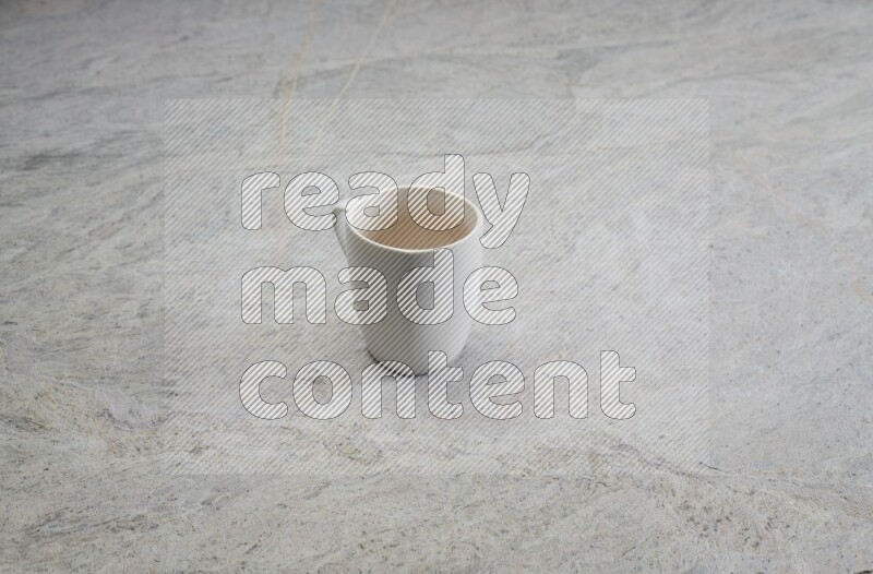 A white ceramic mug on grey marble background