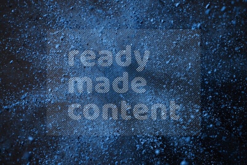 Blue powder explosion on black background