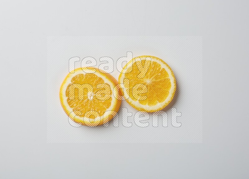 Two orange slices on white background