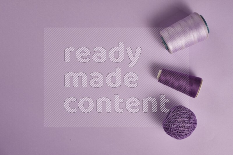 A purple collection of sewing and tailoring tools arranged on a purple background