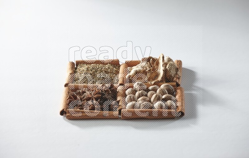 4 squares of cinnamon sticks full of star anise, ginger, cumin and nutmeg on white flooring
